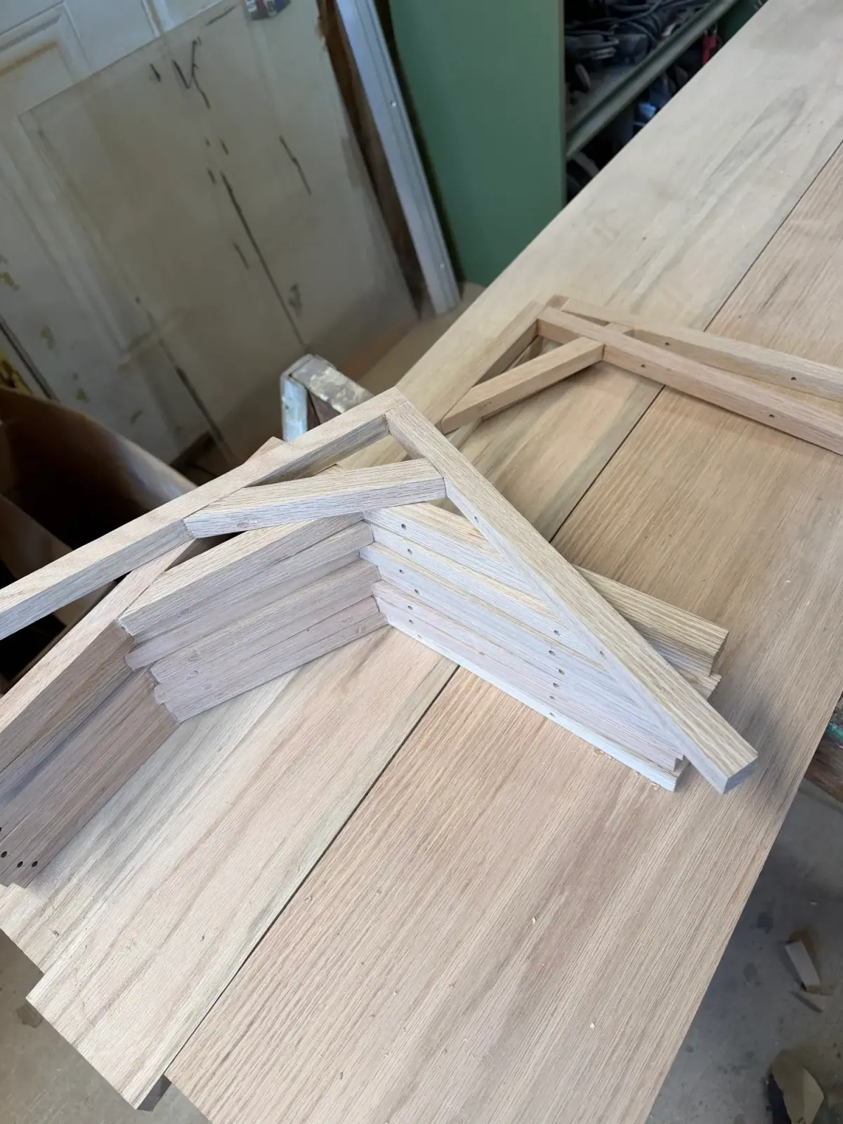 White oak shelf brackets laid out on the shop bench